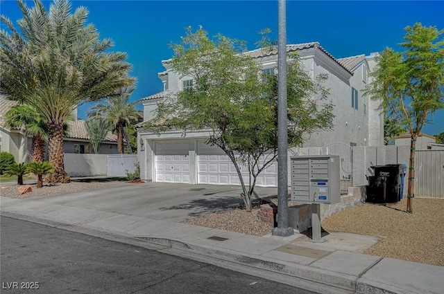 view of front of property featuring an attached garage, fence, driveway, a tiled roof, and stucco siding