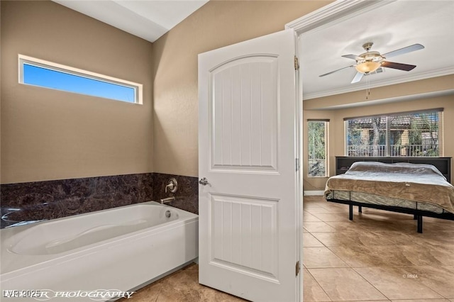 bathroom with tile patterned floors, a wealth of natural light, ceiling fan, and a bath