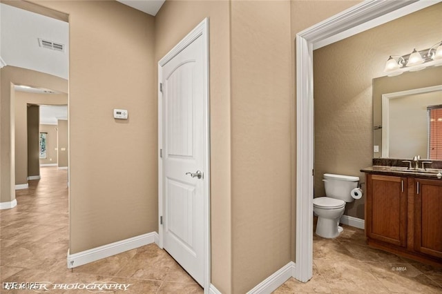 bathroom with toilet and vanity