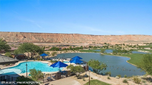 drone / aerial view with a water and mountain view