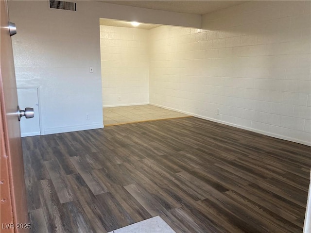 unfurnished room with dark hardwood / wood-style floors