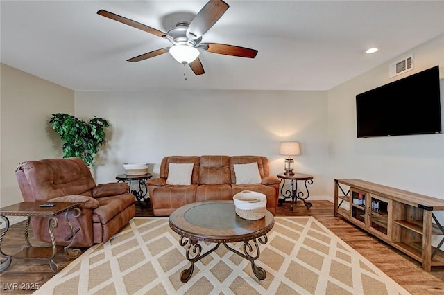 living room featuring ceiling fan and wood-type flooring