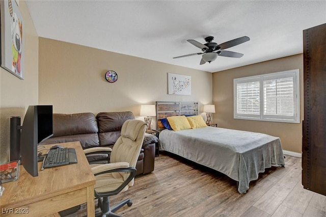 bedroom with light hardwood / wood-style flooring and ceiling fan