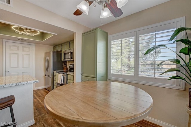 dining space featuring ceiling fan and dark wood-type flooring