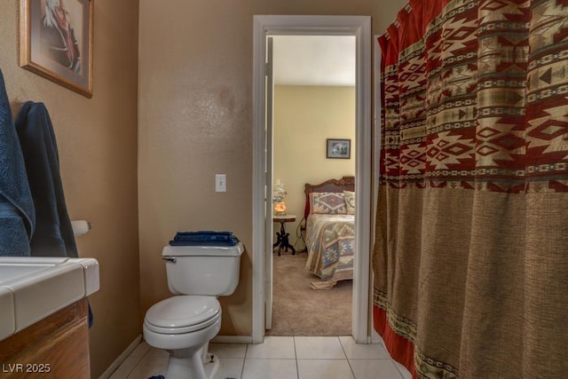 bathroom featuring vanity, tile patterned flooring, and toilet