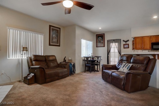 carpeted living room featuring ceiling fan