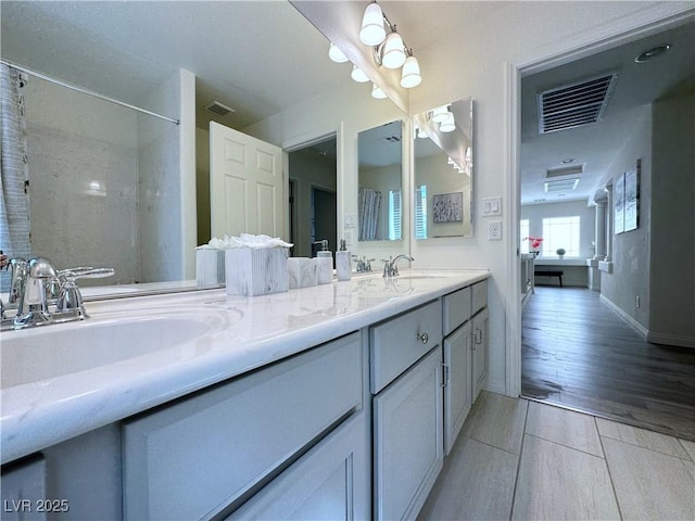 bathroom featuring tile patterned flooring and vanity