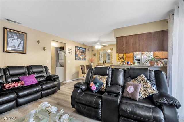 living room featuring ceiling fan and light wood-type flooring