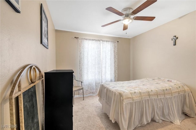 bedroom featuring ceiling fan and light carpet