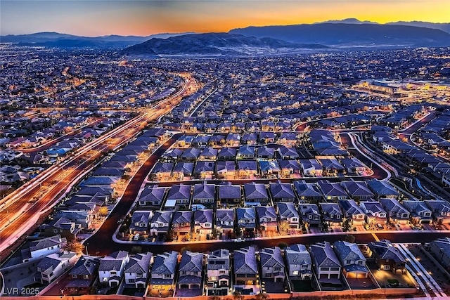 aerial view at dusk featuring a mountain view