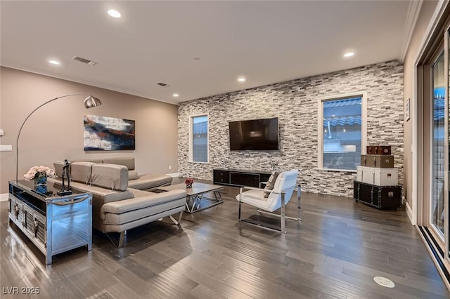 living room featuring dark wood-type flooring and crown molding