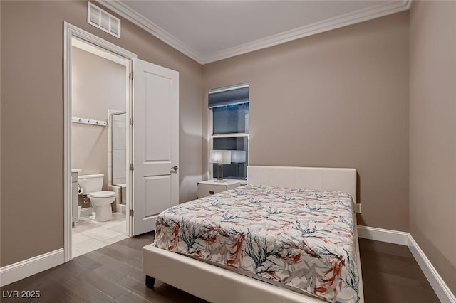 bedroom featuring ensuite bath, crown molding, and hardwood / wood-style floors