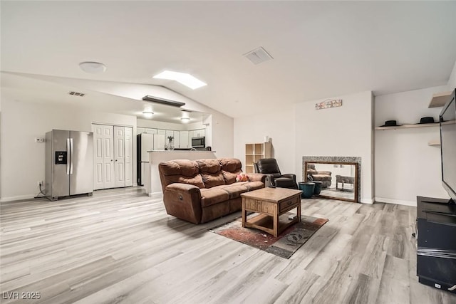 living room featuring light hardwood / wood-style flooring and lofted ceiling