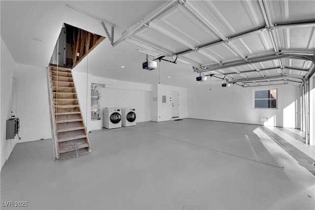 garage featuring a garage door opener and separate washer and dryer