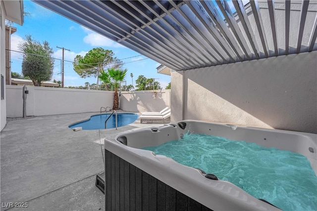 view of swimming pool featuring a hot tub