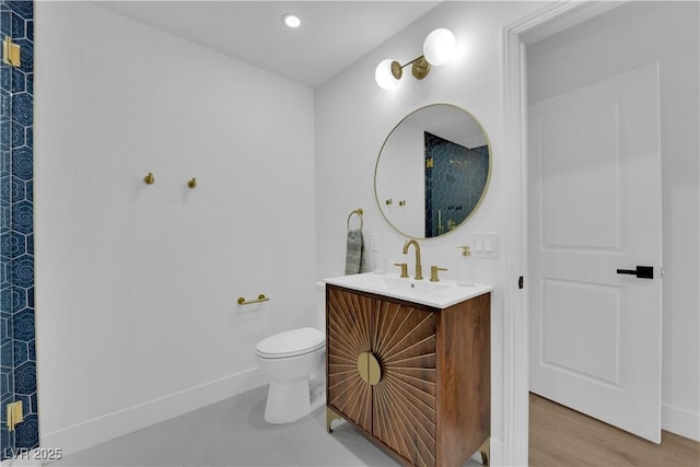 bathroom featuring hardwood / wood-style flooring, vanity, and toilet