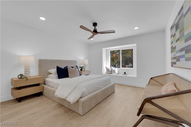 bedroom with ceiling fan and light hardwood / wood-style floors