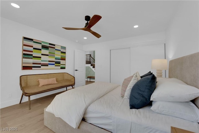 bedroom with a closet, ceiling fan, and light hardwood / wood-style flooring