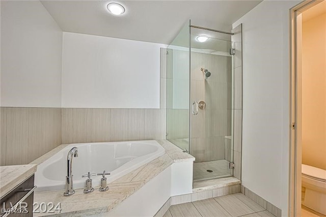 full bathroom with toilet, separate shower and tub, and vanity