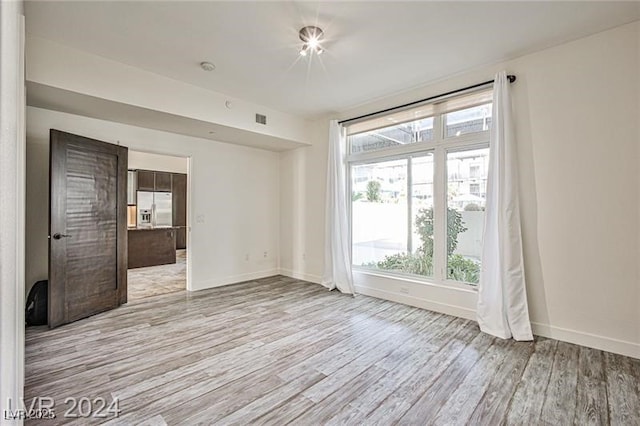 empty room with light wood-type flooring