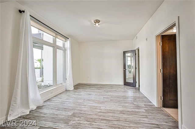 spare room featuring light wood-type flooring