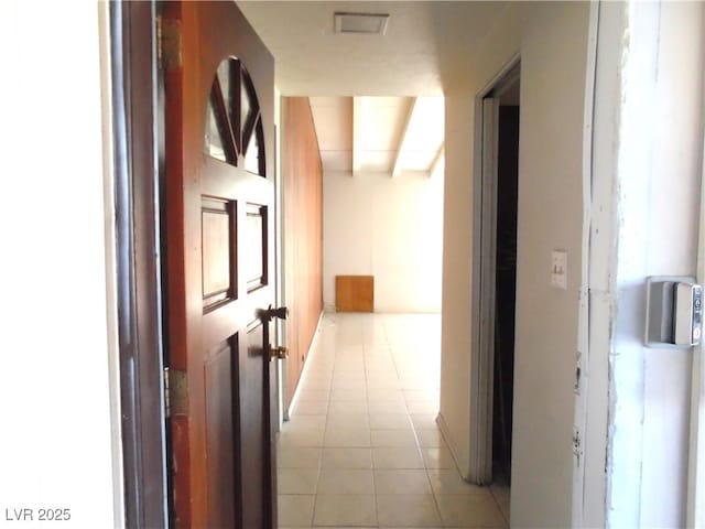 hallway with light tile patterned floors