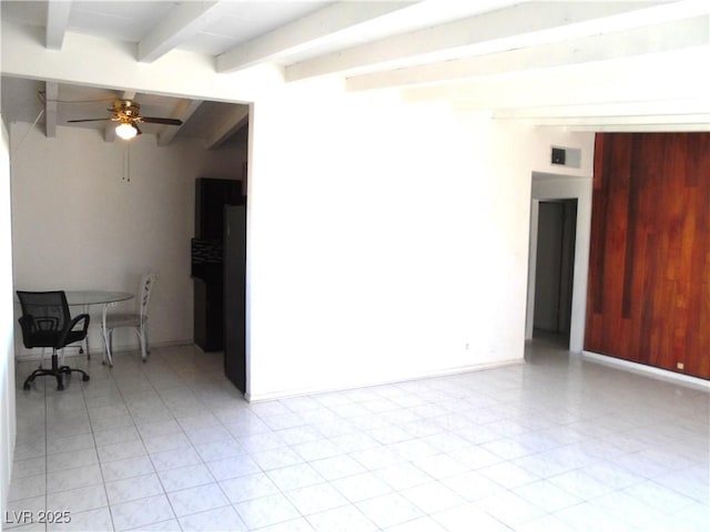 empty room featuring beam ceiling and ceiling fan