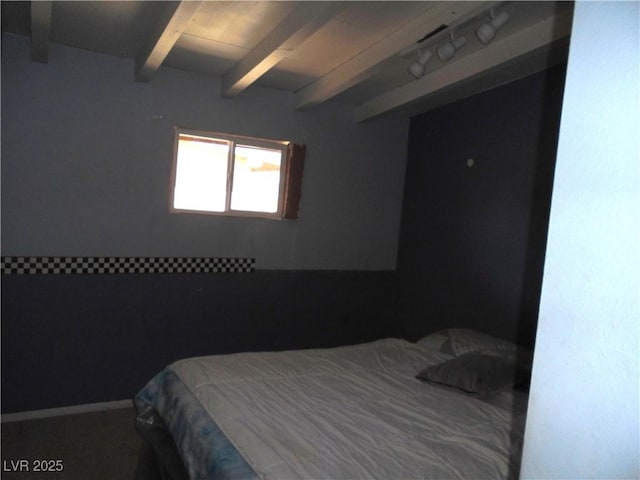 bedroom with beam ceiling