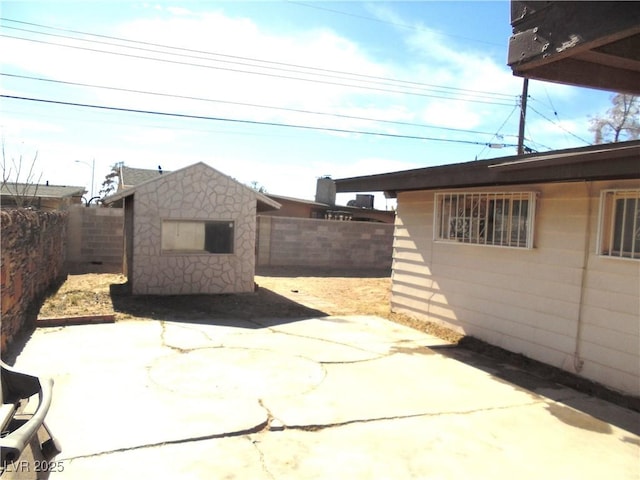 view of patio with a storage shed