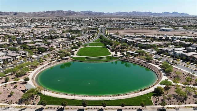 drone / aerial view featuring a water and mountain view