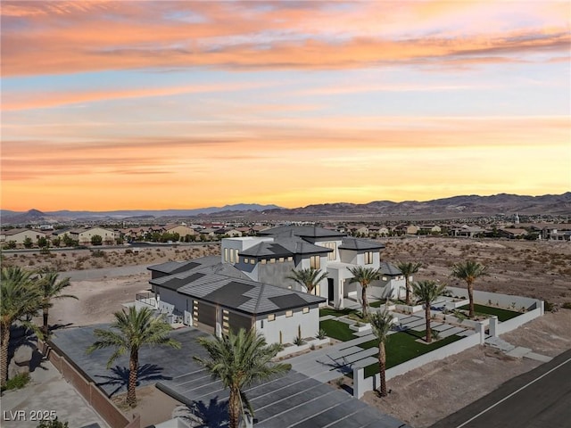 aerial view at dusk featuring a mountain view