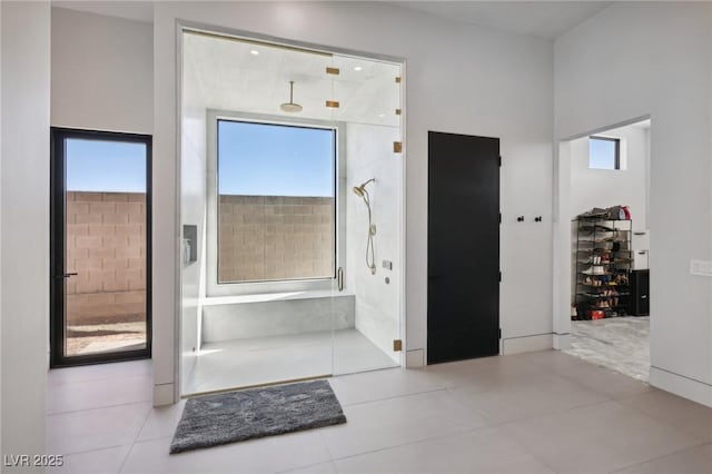 bathroom featuring tile patterned flooring and a shower with door