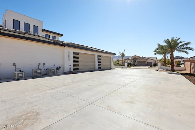 view of side of property with central AC and a garage