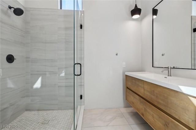 bathroom with vanity and a shower with door