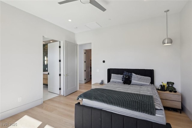 bedroom featuring ensuite bathroom, light wood-type flooring, and ceiling fan