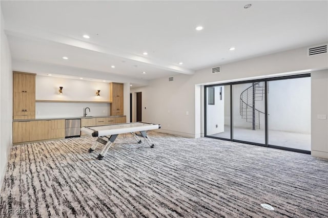 playroom featuring beam ceiling, sink, and light colored carpet