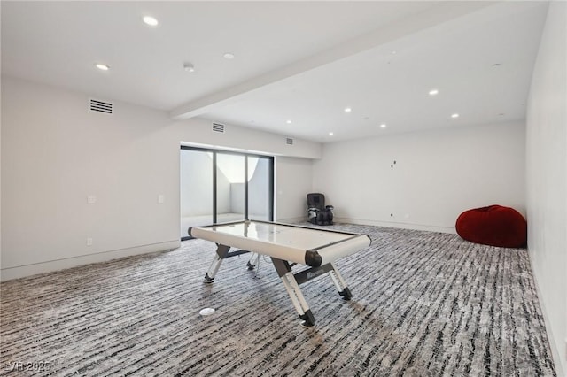 rec room featuring carpet and beam ceiling