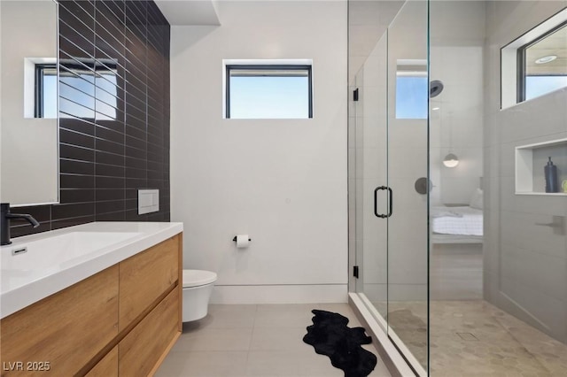 bathroom with plenty of natural light, tile patterned flooring, toilet, and walk in shower