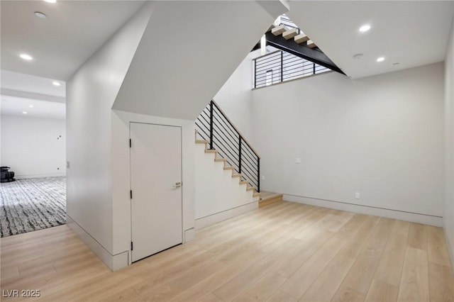 staircase with hardwood / wood-style floors