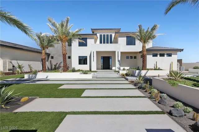 view of front of home featuring a balcony and a front lawn