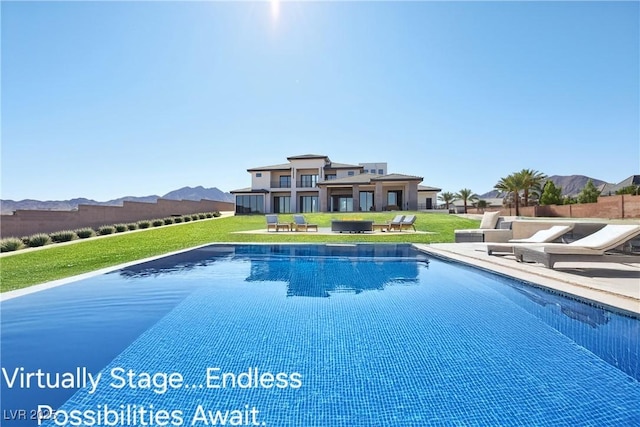 view of swimming pool with a yard and a mountain view