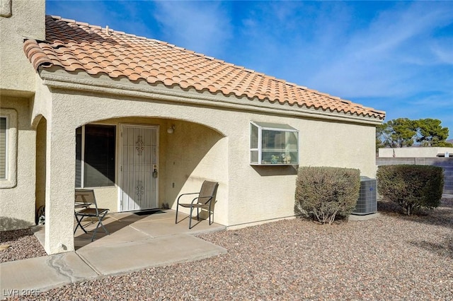 rear view of property featuring a patio and central AC unit