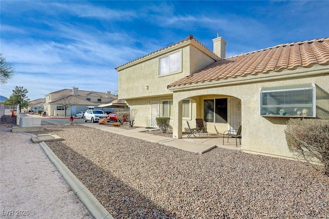 rear view of property featuring a patio