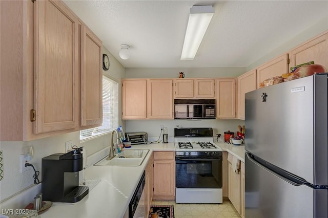 kitchen featuring sink, light brown cabinets, and stainless steel appliances