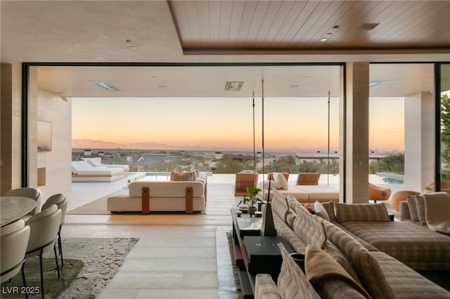 living room with wooden ceiling and expansive windows