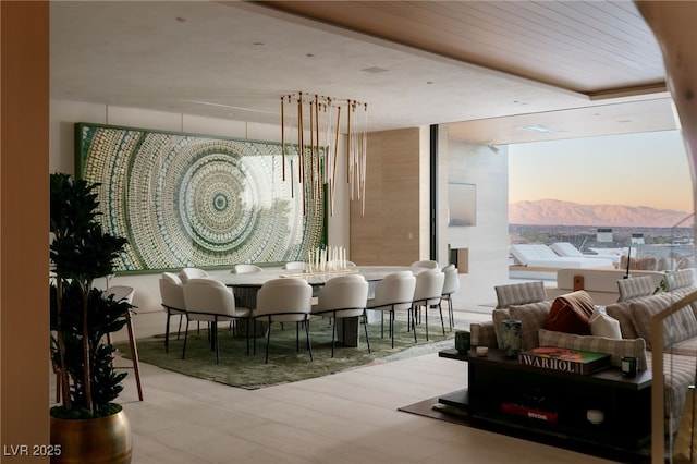 dining area featuring a mountain view and light hardwood / wood-style flooring