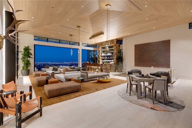 living room featuring hardwood / wood-style floors, expansive windows, wood ceiling, and a high ceiling