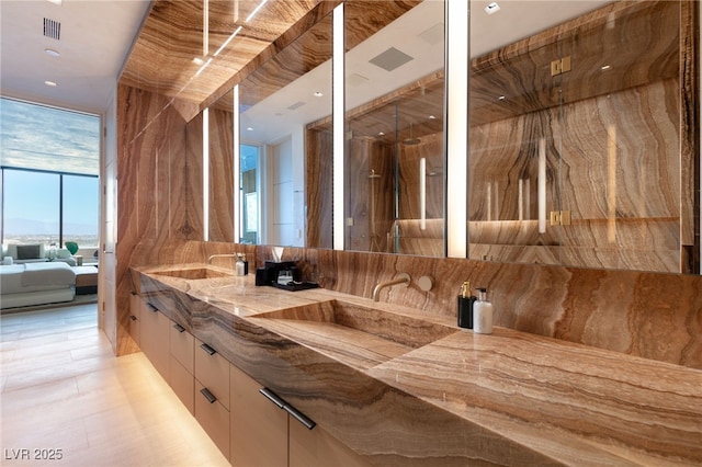 bathroom featuring vanity and expansive windows