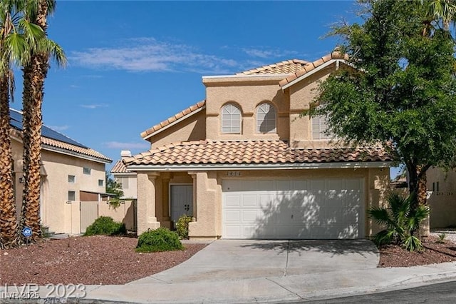 mediterranean / spanish-style house with a garage