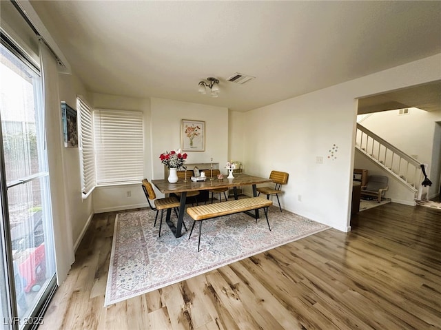 dining space featuring wood-type flooring